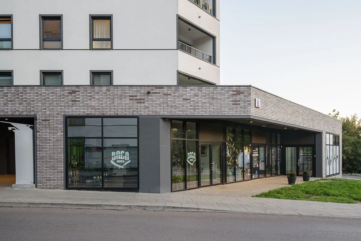 Brick plinth with the shopfronts of the ground-floor commercial units